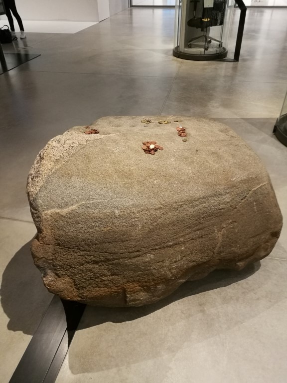 Une pierre sur laquelle des visiteurs du musée ont fait des offrandes